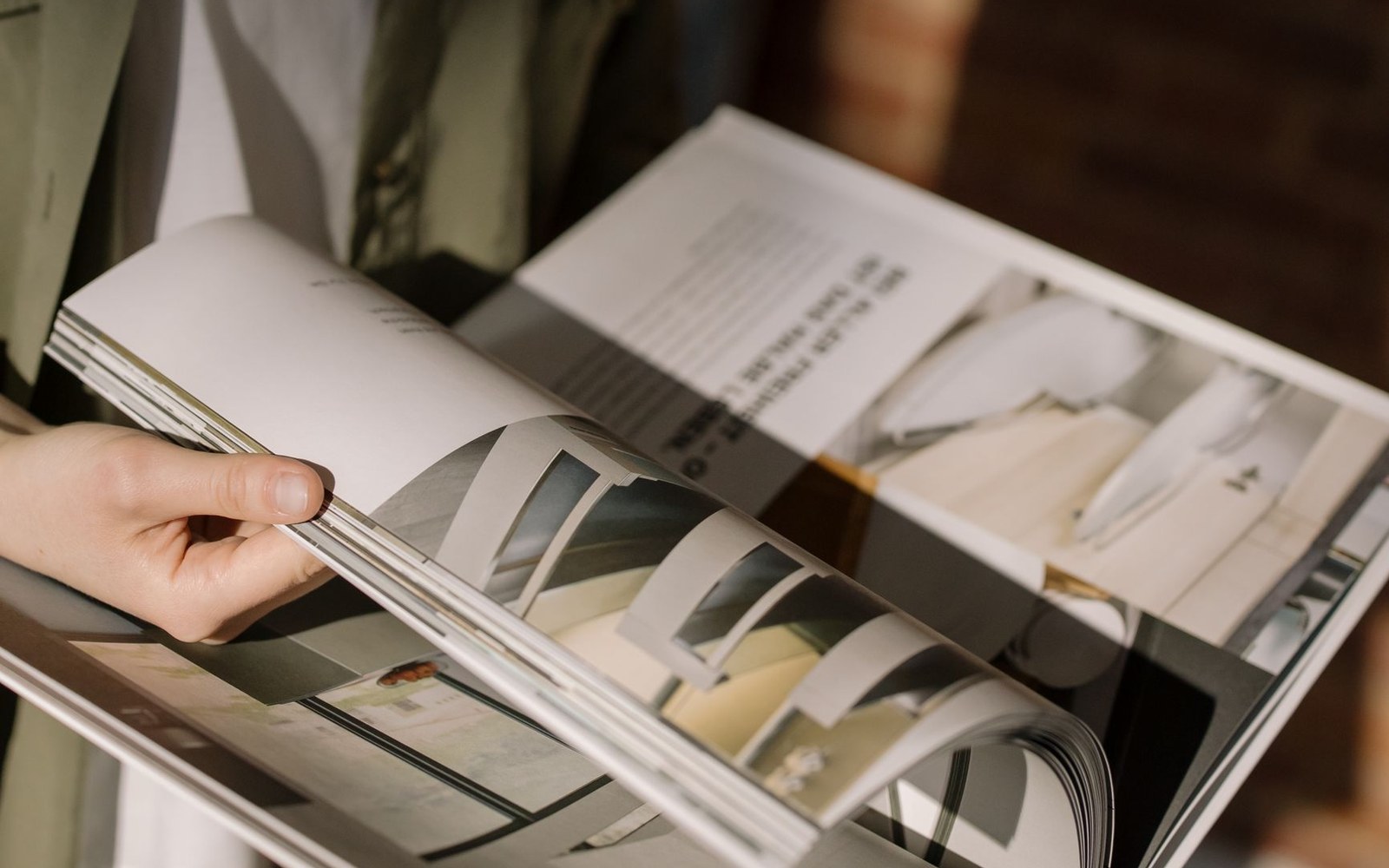 A printed regulation open flat at a numbered article, a hand resting at the margin, photographed in natural window light