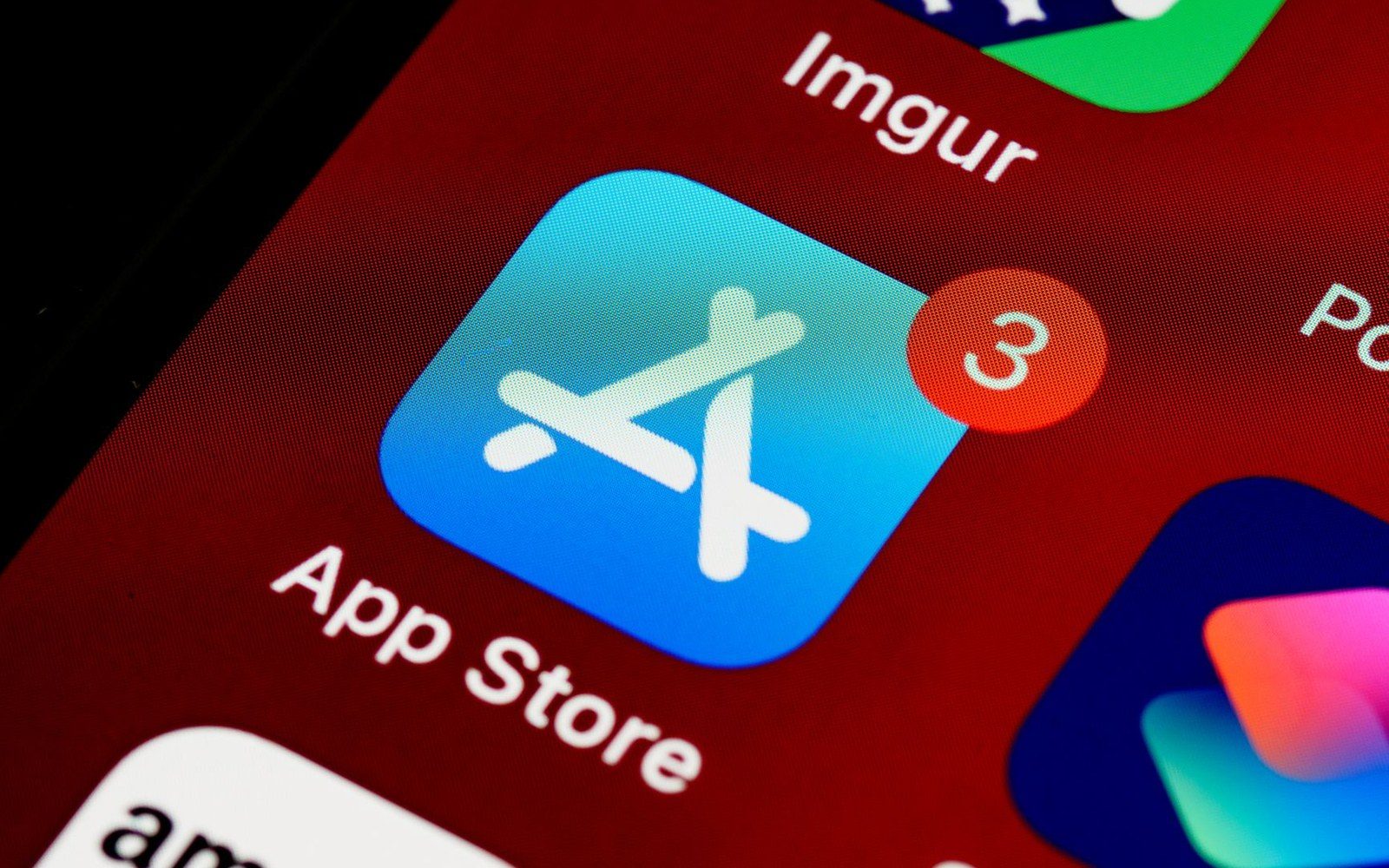 App Store icon with three pending updates shown on a smartphone home screen