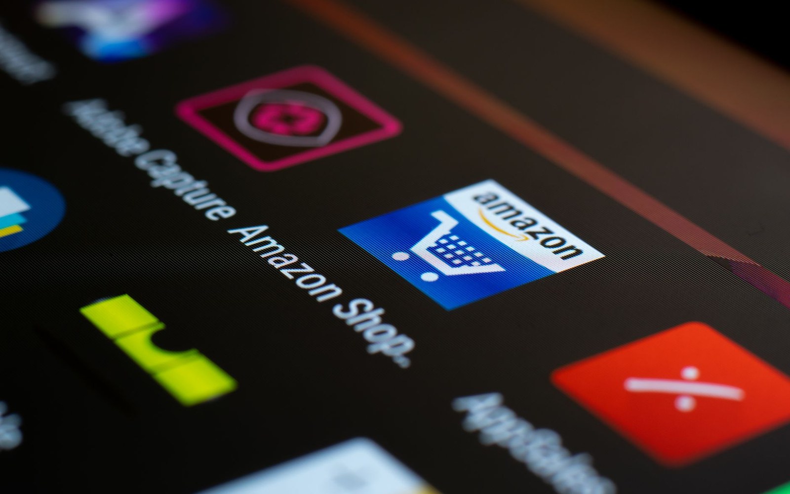 Close-up of a smartphone screen showing the Amazon Shop app icon among other apps