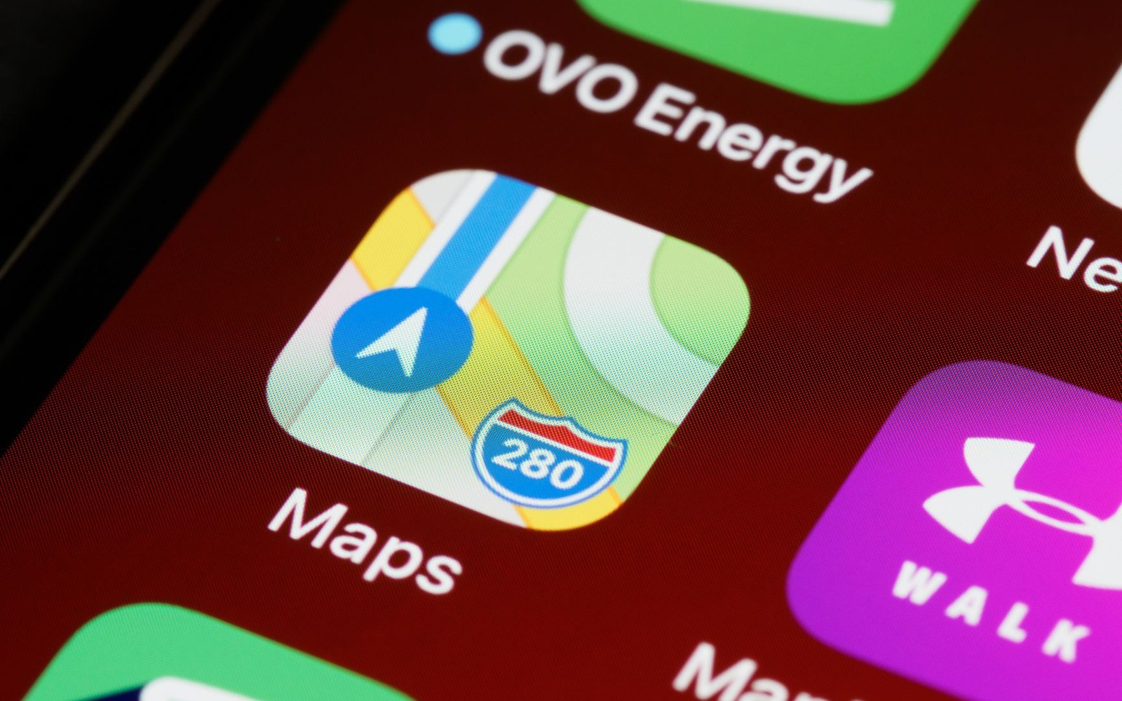 Close-up of a smartphone home screen showing the Apple Maps app icon